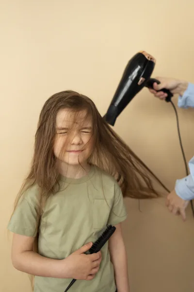 Child enjoying a gentle blow-dry hairstyle at Star Coco Melon kids salon in Dubai
